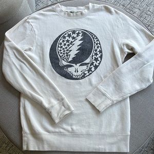 Junk Food sweatshirt with black metallic skull and dark cream cotton.